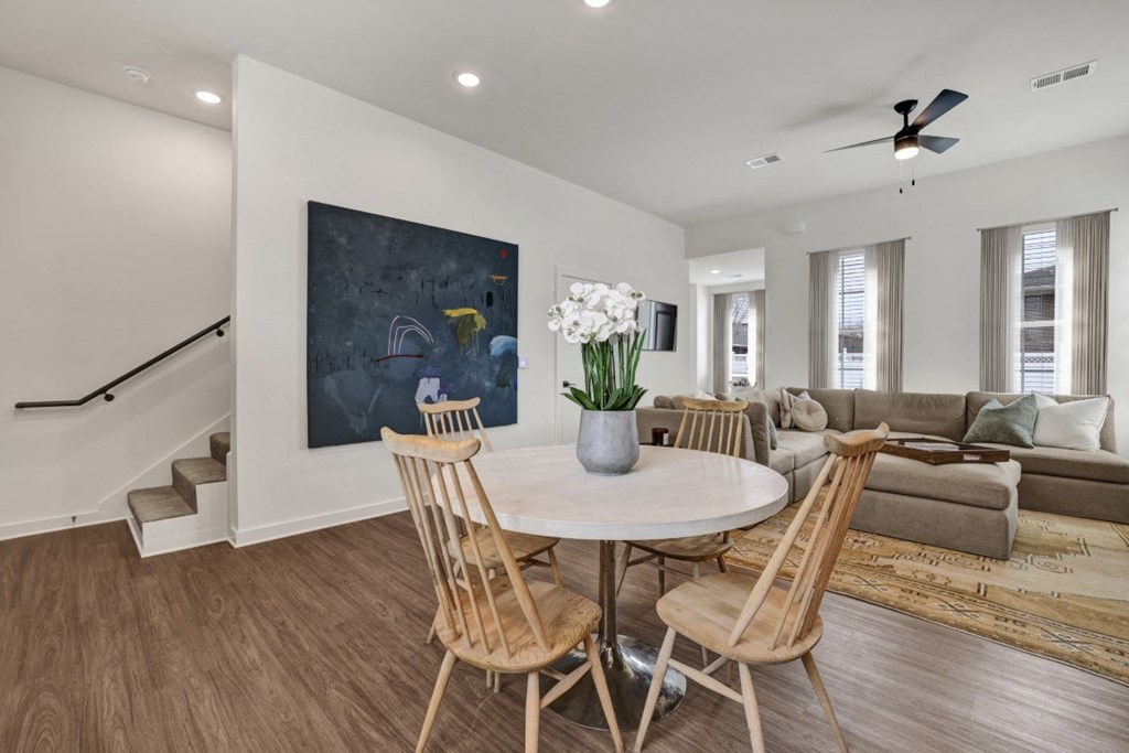 Open floor plan living and dining area with wood-designed flooring at West Row Townhomes and at West Row Townhomes at West Row Lofts and Townhomes in Birmingham, AL